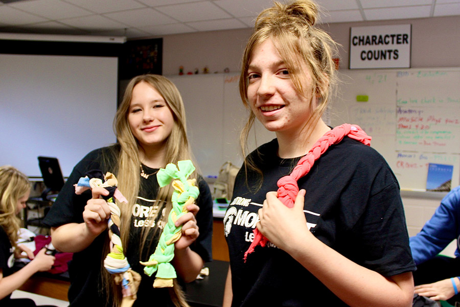 Junior Zoe Linderman, left, and sophomore Shylee Benham-Richards chose to make dog toys for local animal shelters out of old T-shirts because of their mutual love for canines